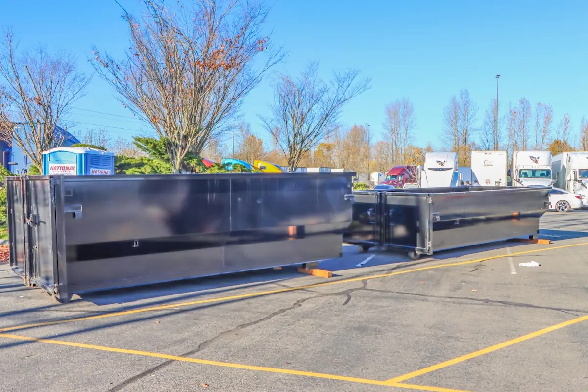 Professional dumpster rental service with roll-off container on residential driveway in Peekskill